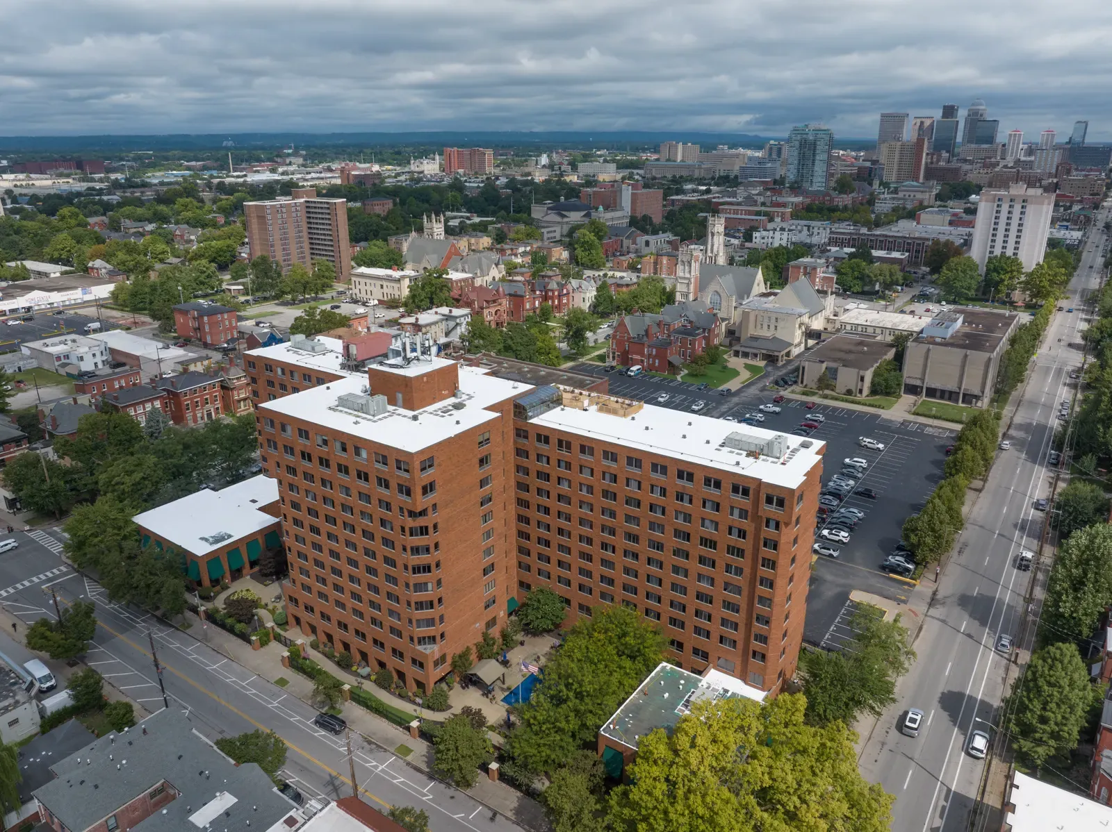 Treyton Oak Towers from above with white roofs and the downtown Louisville skyline in the distance