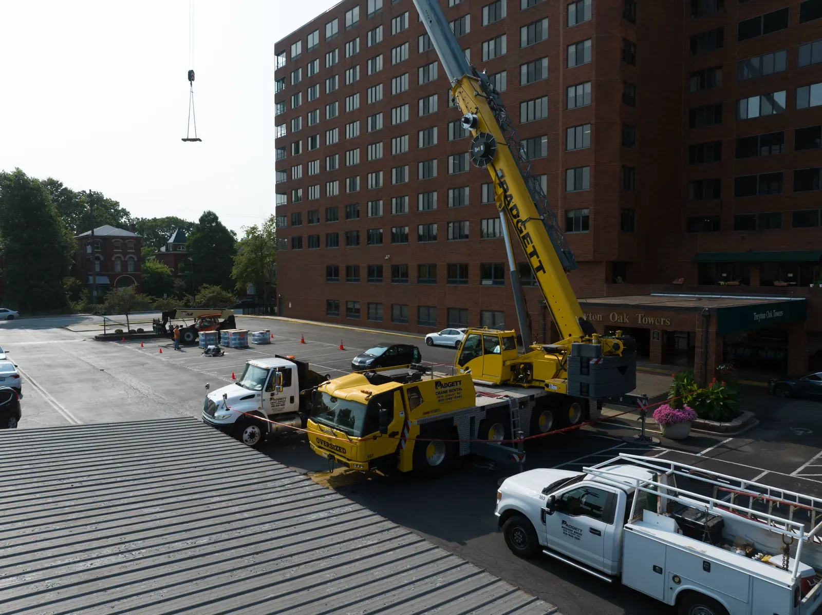 Mobile crane rigged in front of the Treyton Oak Towers entrance canopy