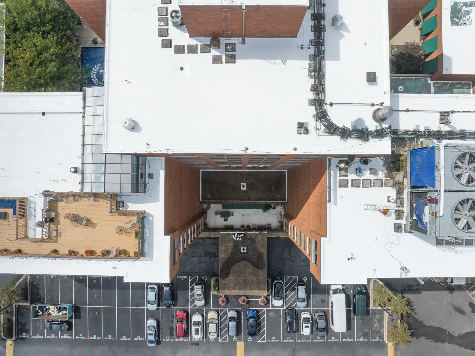 Straight-down aerial of the Treyton Oak Towers roofs and front parking lot, marked with numbers that match the list beside it